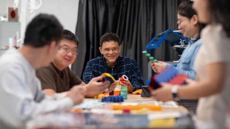 Professor Paulino surrounded by students