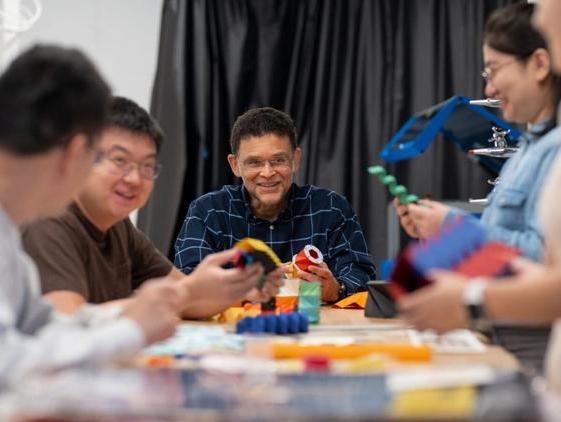 Professor Paulino surrounded by students